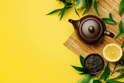 Relaxing Tea Time With a Teapot, Leaves, Lemon, and Green Tea on a Bamboo Mat photo