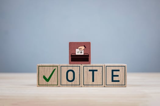 Wooden block with the letters VOTE and a check mark. Concept of election, political election campaign, voting and democratic rights exercise system photo