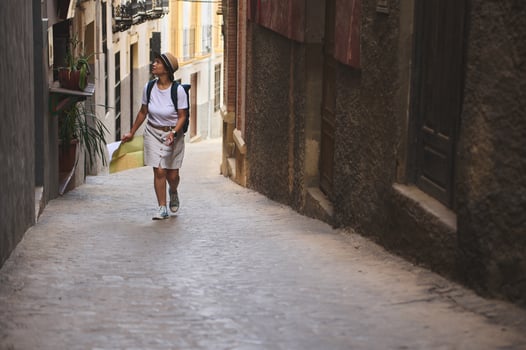 Woman Exploring Historic Streets of a Quaint European Village photo