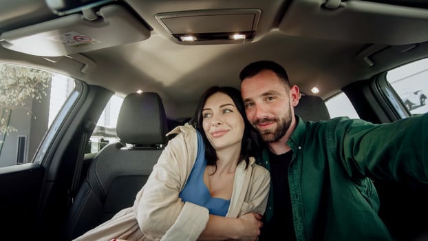 Couple taking a selfie in a car photo