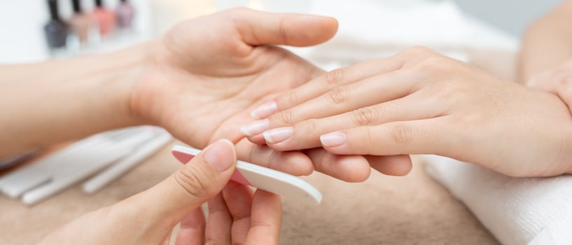 service by professional Beautician Manicure at spa centre. Nail beauty salon use nail file for Glazing treatment. manicurist make nail customer to beautiful. body care spa treatment photo