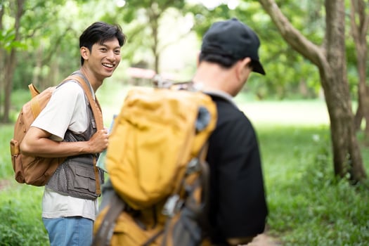 Joyful Hiking Experience. Son smiling at his father during their adventure. photo
