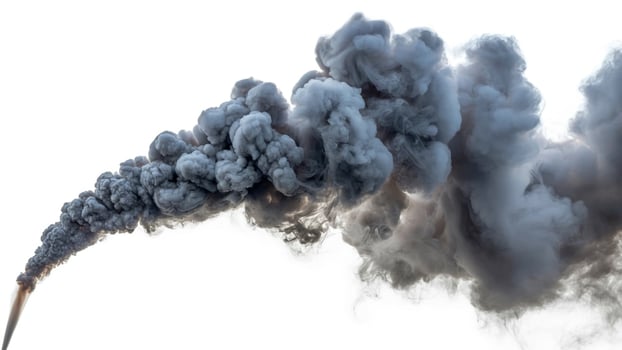 A plume of dark gray smoke rising and billowing against a bright white background outdoors photo