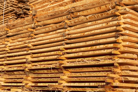 Stacked raw boards on a sawmill. Sawn boards. Wood industry photo