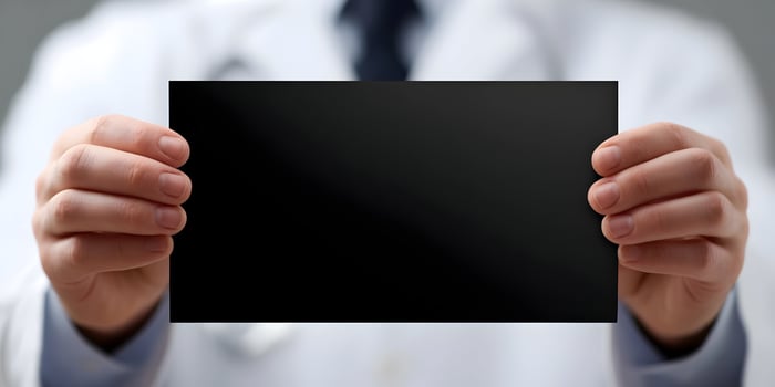 Doctor Holding Blank Black Rectangle Card Mockup photo