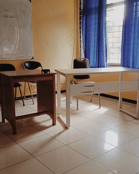 A white desk with a chair and a table photo