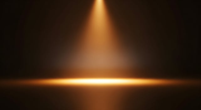 Golden-Orange Vertical Spotlight Illuminating Dark Stage-Like Space photo