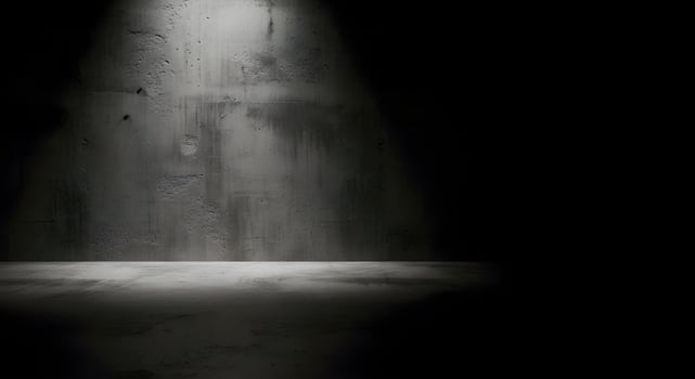 Concrete Room with Dramatic Diagonal Light and Deep Shadows photo