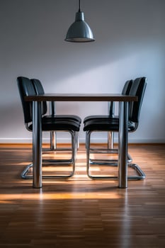 Bauhaus dining room table with black chairs and modern pendant light photo