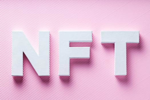 NFT White Letters on Pink Diagonal Striped Background, Crypto Art Concept, Top View photo