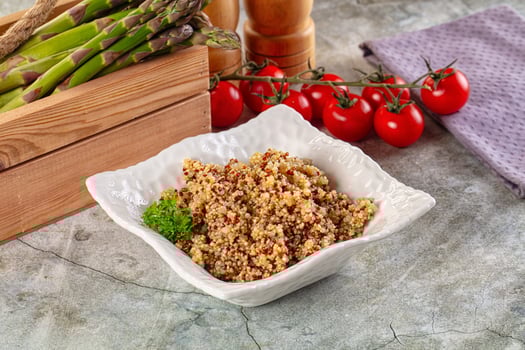 A bowl of asparagus and rice with tomatoes photo