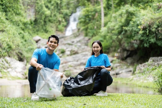 Volunteer Clean-Up. Two volunteers collecting trash in a beautiful natural setting. photo