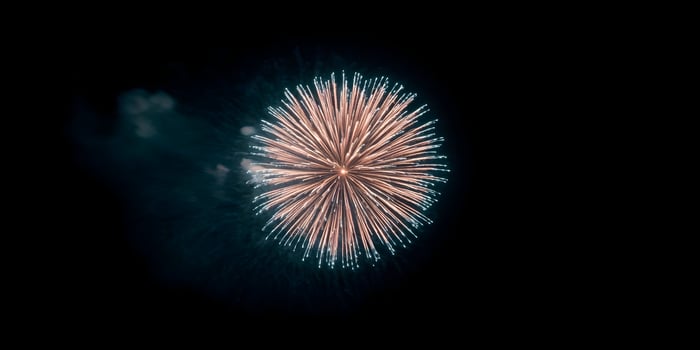Peach and Teal Fireworks Burst at Night photo