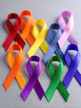 Colors of Awareness Ribbons Representing Various Male Health Issues Displayed Neatly Against a Gray Background photo
