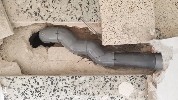 Sewage pipe installation and repair process in a residential building under renovation photo