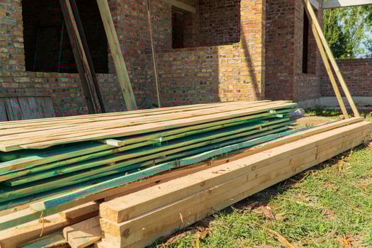Construction of a family house. Boards for construction. Modern construction of a residential building. Building material photo