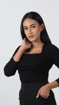 Elegant fashion model, in a chic black outfit poses confidently in a studio. photo