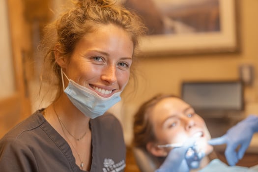 A woman smiles while sitting in a dental chair photo