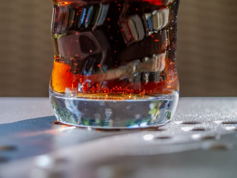 Glass of soda with a swirl pattern on the side photo