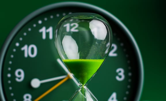 Hourglass stops time of work and life. Process and rules of limited time. photo