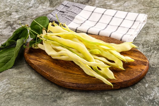 A wooden cutting board with a bunch of beans on it photo