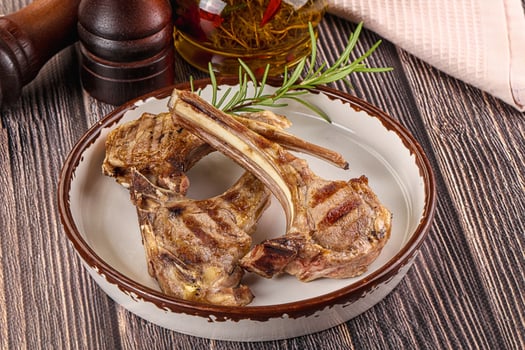 A plate with two lamb chops on it photo