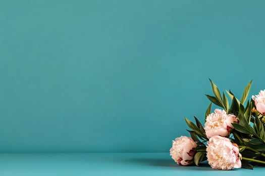 Bouquet of Soft Pink Flowers Arranged Against a Turquoise Background for Floral Decoration photo