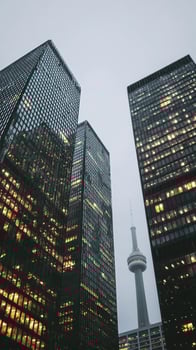Urban Skyline With Modern Glass Buildings and Tower During Overcast Evening photo