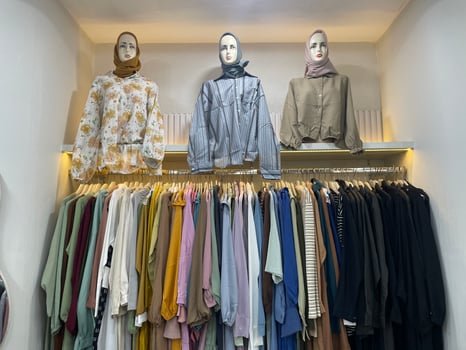 Stylish Hijab Fashion Display with Mannequins and Pastel Modest Outfits in Boutique Setting photo