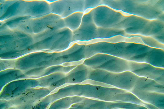 Underwater Sand Ripples with Sunlight Reflections, Ocean Floor Texture Abstract View photo