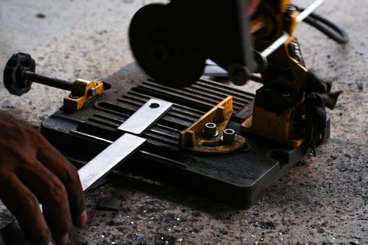 cutting a steel plate with an electric cutting wheel with motion at a factory photo