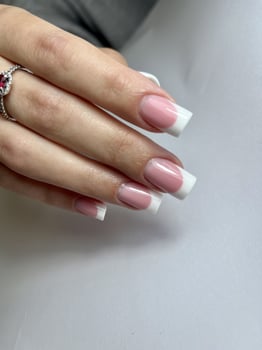 Woman's hand with white french manicure, nail design, wedding manicure photo