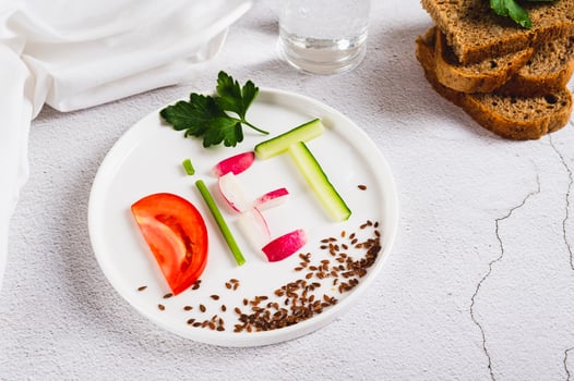 The word diet from vegetables on a plate, bread and a glass of water on the table photo