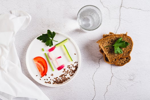 Concept diet on a plate of low-calorie foods on the table top view photo