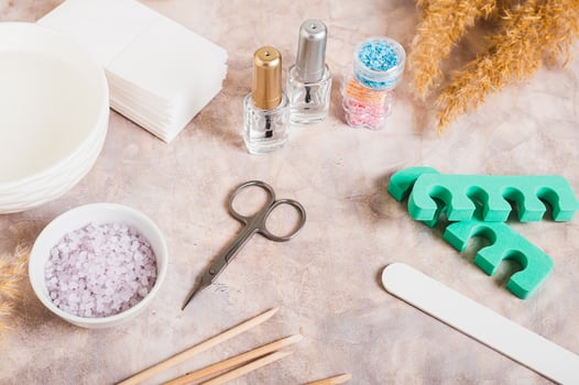 Manicure scissors, nail file, nail polish and other items on the table photo