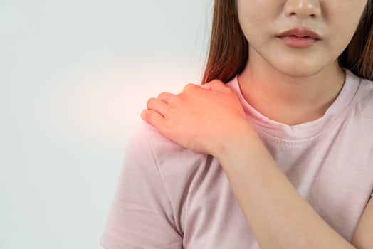 woman holding on shoulder and while and suffer from unbearable pain health and problems, chronic shoulder pain, shoulder ache in office syndrome, scoliosis, herniated disc, muscle inflammation photo