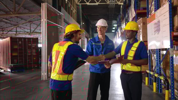 A bunch of warehouse workers are reviewing the list of items based on the documentation,39 photo