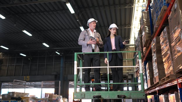 Business woman and warehouse workers are reviewing the list of items based on the documentation,7 photo