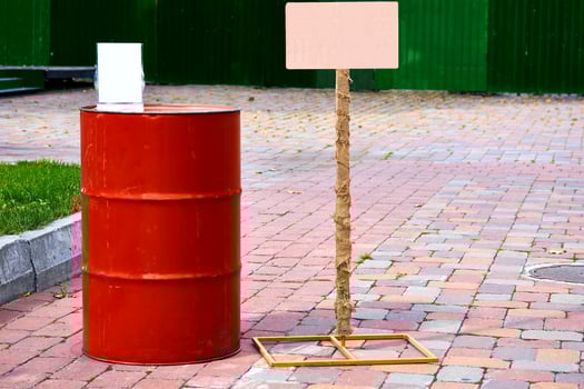Red iron barrel for fuel, lubricating oil in front with frames photo