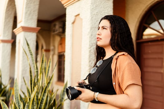 Young female photographer exploring new city with camera in hand photo
