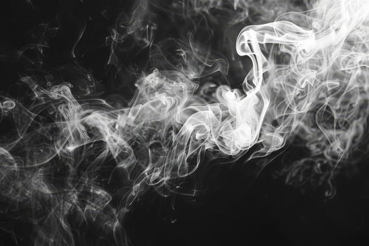 Delicate tendrils of white smoke twist and swirl against a deep black canvas, evoking a sense of enchantment and intrigue in the air photo