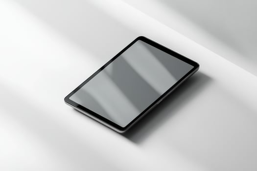 Minimalist Tablet on White Surface with Shadow Play and Subtle Lighting photo