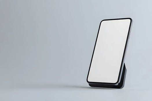 Modern Smartphone Displayed on a Stand Against a Minimalist Grey photo