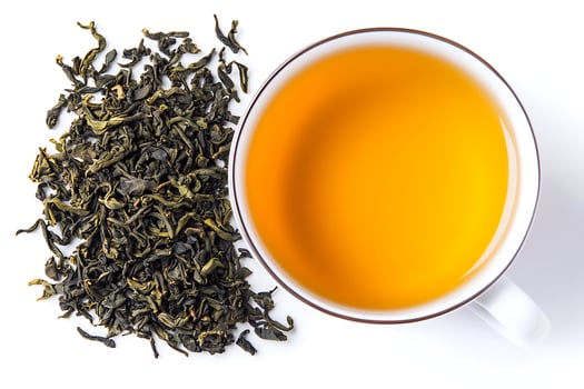Hot Tea with a Touch of Nature on white background. photo