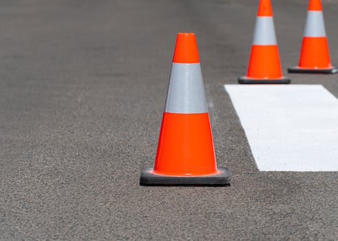 Road traffic cones standing on street on gray asphalt during road construction works. Traffic cones for road works photo