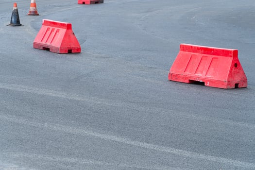 Plastic road fencing. Red barriers on the road. Road works photo
