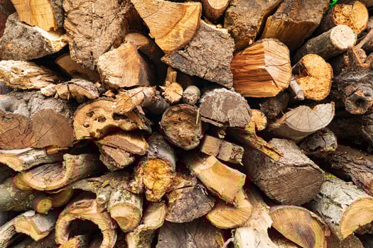 Finely chopped firewood. Pile of dry chopped stacked firewood. Preparation of firewood for the winter. Firewood background photo