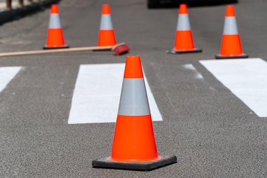 Road repair, cone in the foreground. Traffic cone. New road markings. Traffic line painting photo