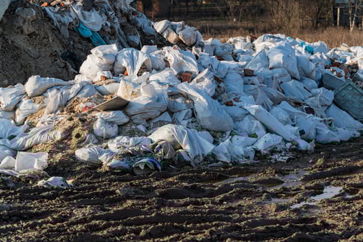 Land with garbage. Trash from household in waste landfill. Construction debris photo