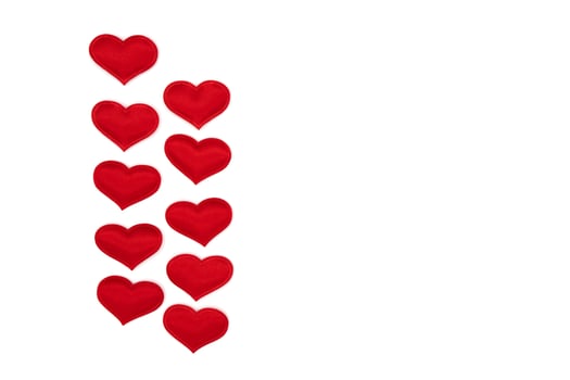 Little red hearts on a white photo